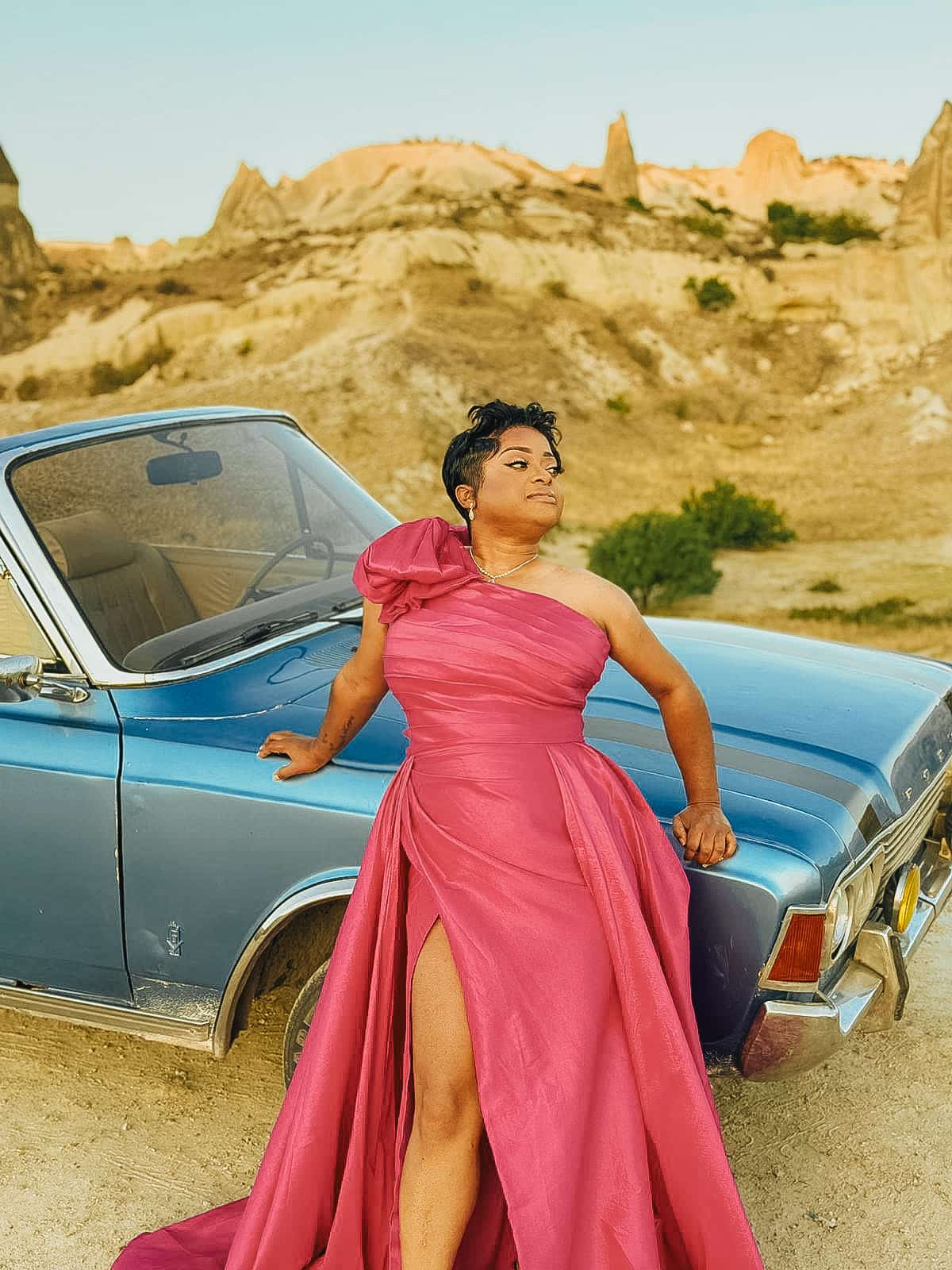 Serena beside a vintage car